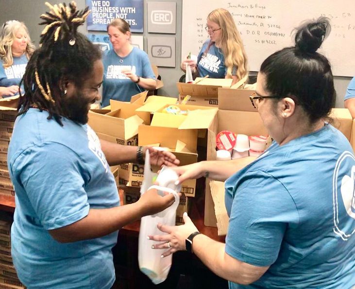 Regency employees packing bags of food