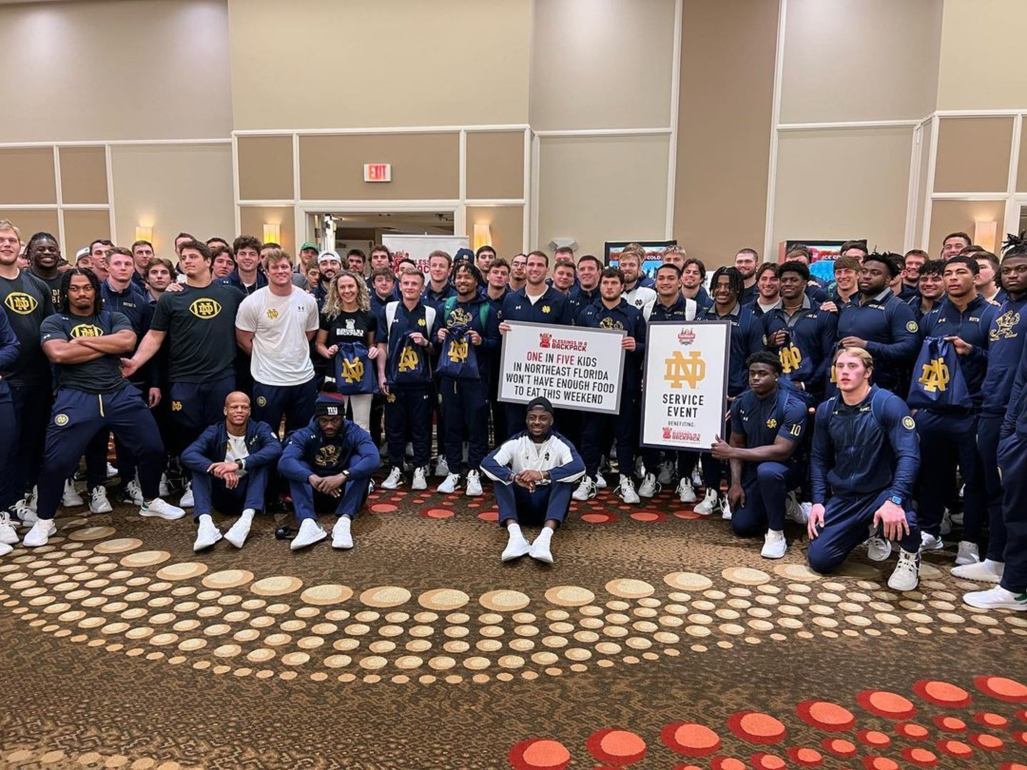Notre Dame Players Fill Backpacks With Food for Children Ahead of Gator Bowl