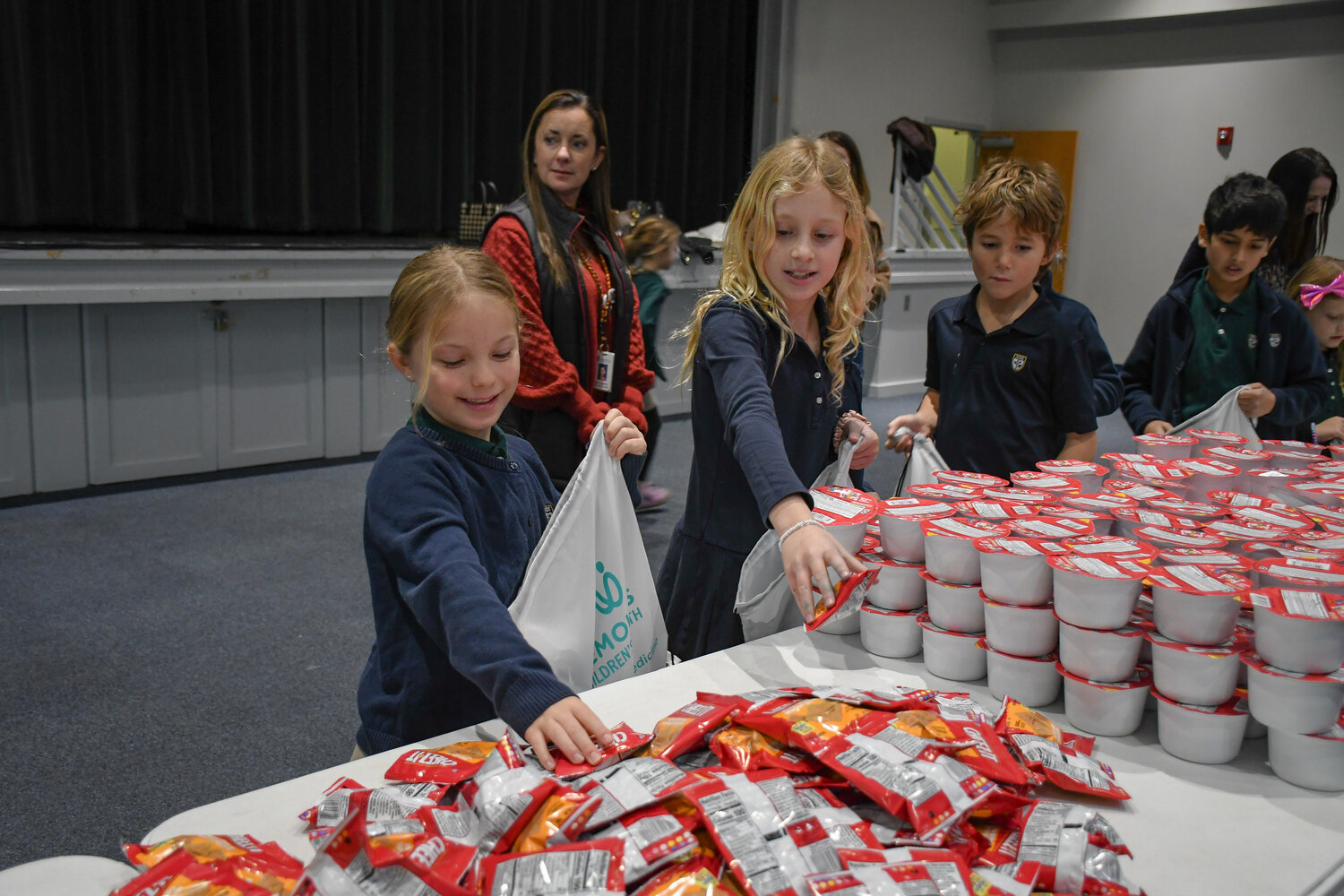 students packing bags of food